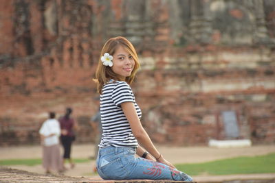 Smiling young woman at park