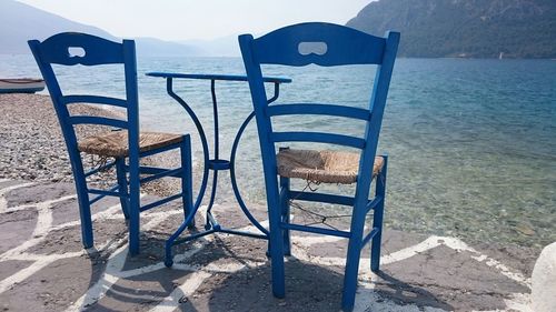 Empty bench in water