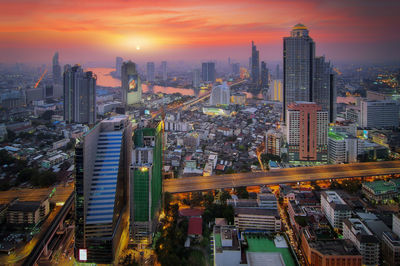 High angle view of illuminated buildings against sky during sunset