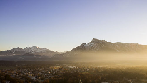 Aerial view of town in mountains against clear sky