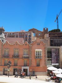 Buildings against clear blue sky