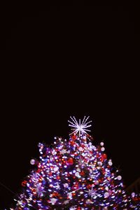 Low angle view of illuminated christmas lights at night