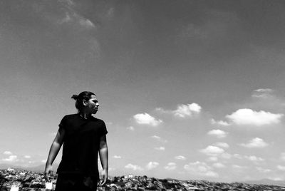 Man standing in city against sky