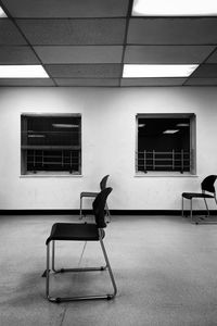 Empty chairs and table in building