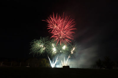 Low angle view of firework display at night