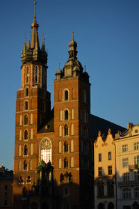 Low angle view of illuminated buildings against clear sky