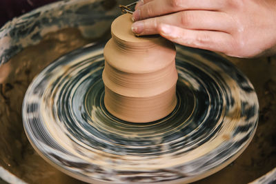 Creating ceramic products of white clay close-up. the sculptor in workshop makes clay jug closeup.