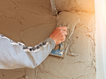 Close-up of woman hand on wall