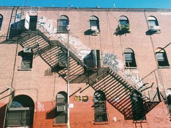 Low angle view of staircase on apartment building in sunlight