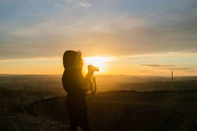 Man photographing at sunset