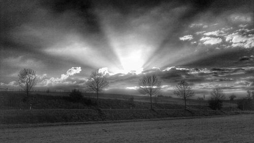 Scenic view of field against cloudy sky