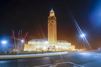 Illuminated buildings against sky at night