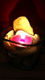 Close-up of burning candle on table