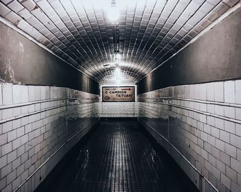 Information sign in corridor of illuminated subway station