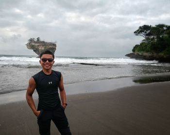 Portrait of man standing on beach