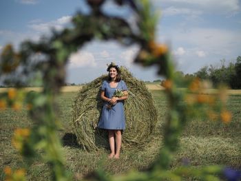 Rear view of woman standing on field