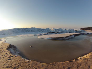 Scenic view of beach against clear sky