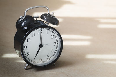 Close-up of clock on table