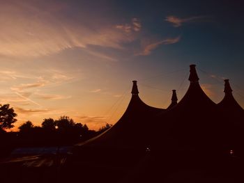 Low angle view of tent against sky during sunset