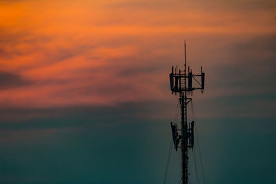 Silhouette crane against sky during sunset