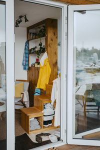 Wooden rack and clothing seen through doorway of house