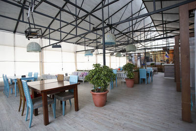Empty chairs and tables in building