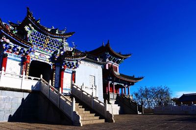 Low angle view of temple against blue sky