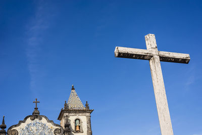 Cement cross of boa viagem church against blue sky. 