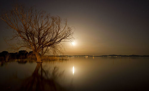 Scenic view of lake against sky during sunset