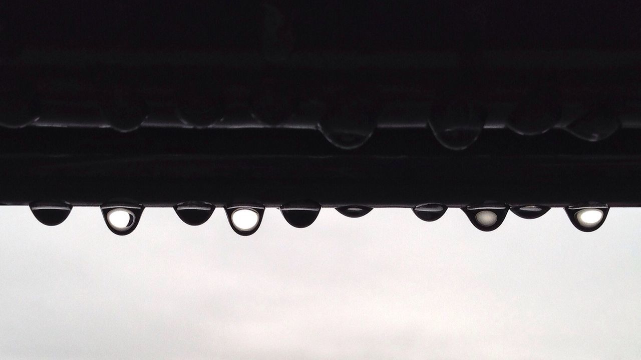 drop, close-up, low angle view, in a row, wet, full frame, water, backgrounds, copy space, weather, nature, metal, sky, repetition, no people, outdoors, detail, pattern, side by side, day