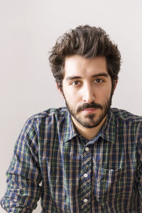 Portrait of man against wall at home