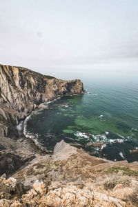 Scenic view of sea and rocks against sky