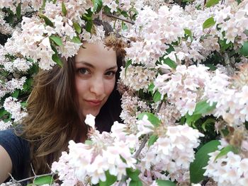 Portrait of beautiful woman amidst flowers