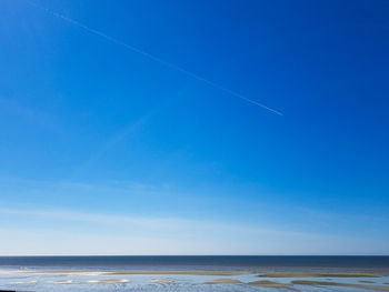 Scenic view of sea against clear blue sky