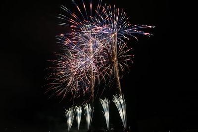 Low angle view of firework display at night