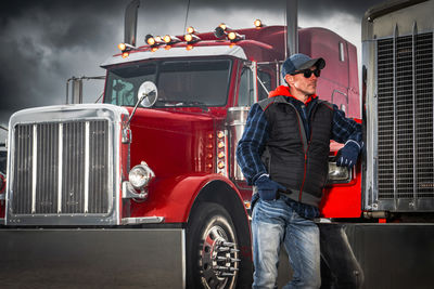 Rear view of man standing in car