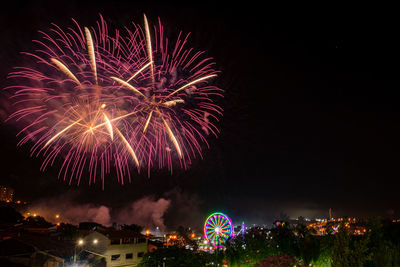 Low angle view of firework display at night