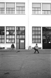 Rear view of man walking on road