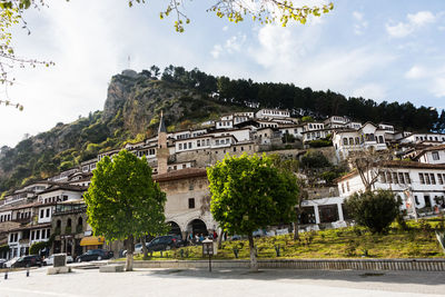 Buildings in town against sky