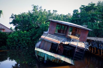 Abandoned boat in lake against sky