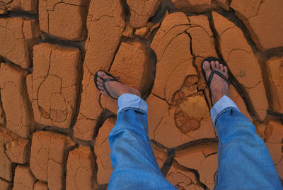 Low section of man walking on rock formation