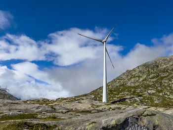 Low angle view of wind turbine against sky