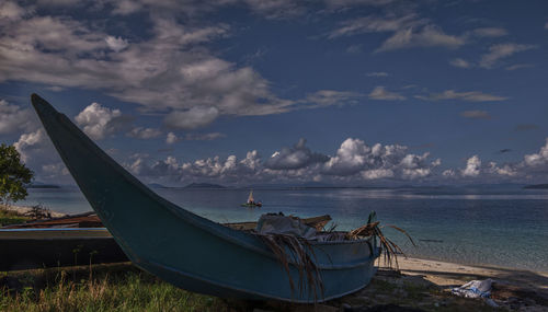 Boats moored on sea against sky