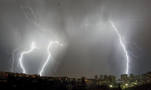 Lightning over cityscape at night