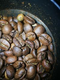 High angle view of roasted coffee beans in container