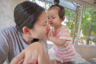Mother and girl looking at camera