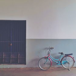 Bicycle parked against wall