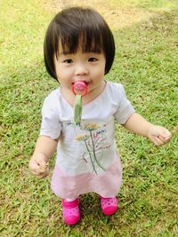 Portrait of cute girl on field