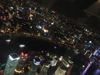 High angle view of city lit up at night