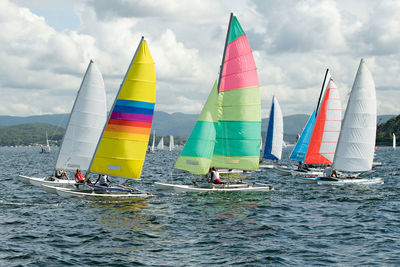 Panoramic view of sailboat sailing in sea against sky